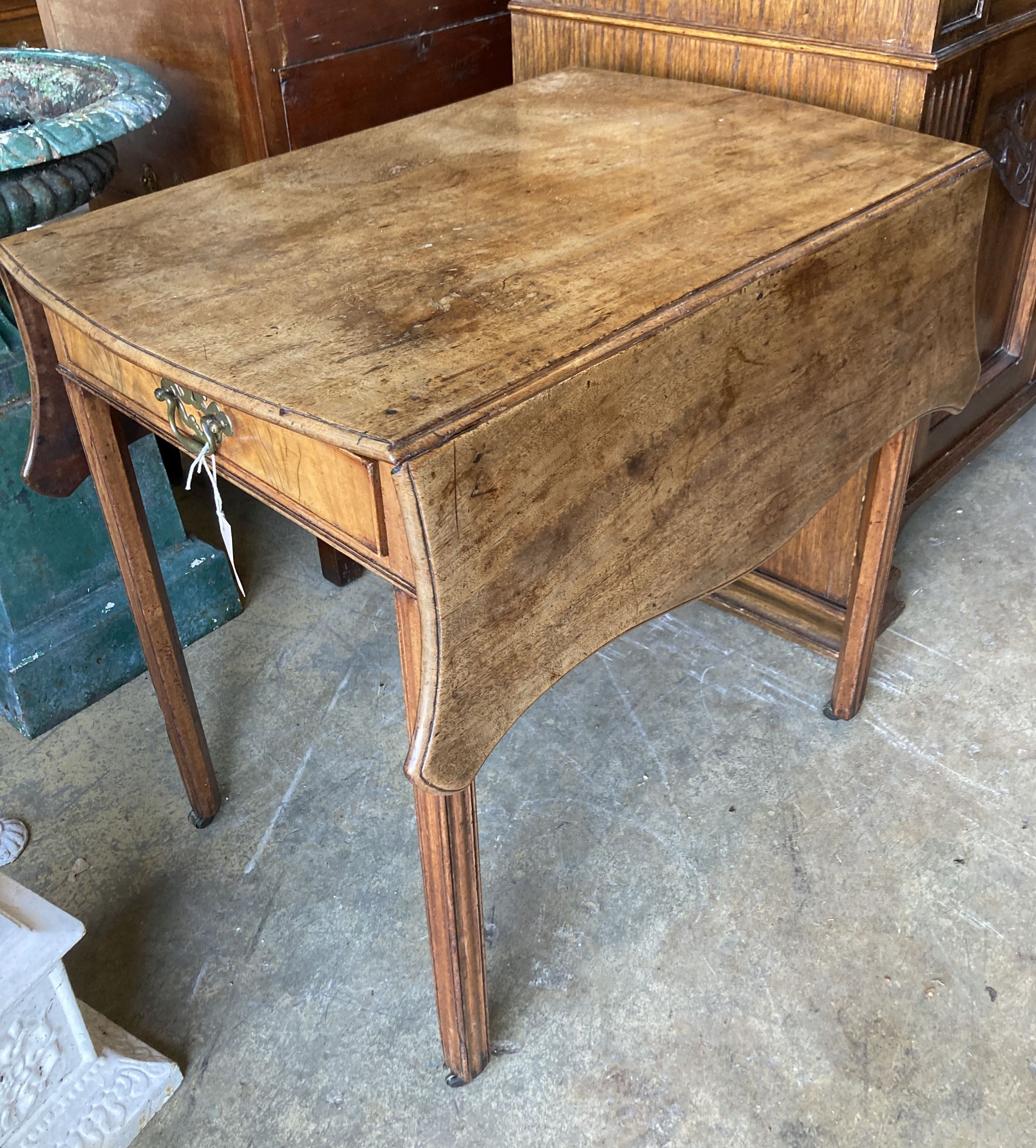 A George III mahogany Pembroke table, with serpentine shaped top, single drawer, on square section supports, width 76cm, depth 52cm, he